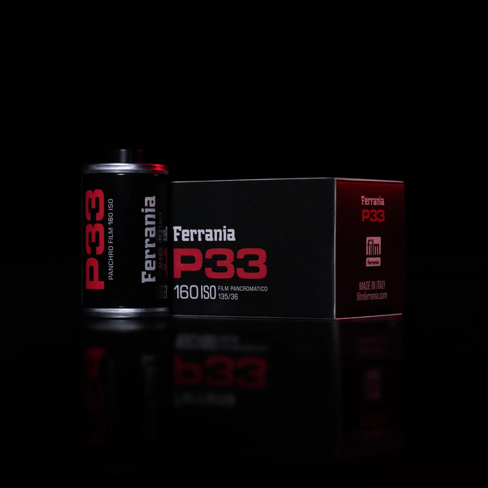 Film Ferrania P30 35mm film cartridge and box on black background
