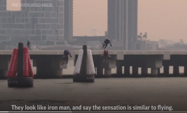 Participants in a jetpack race in Dubai. They are literally flying. 
Caption reads: They look like iron man, and say the sensation is similar to flying.