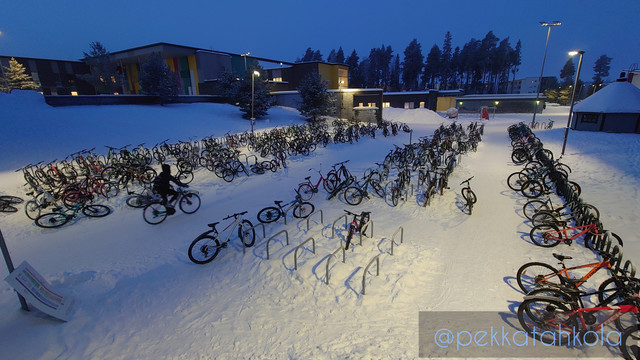 Photo shows hundreds and hundreds of kids' bicycles parked outside a school in a beautiful snowy -31°C early morning scenery.