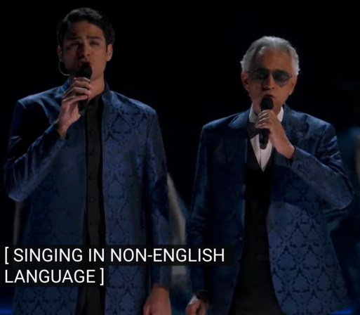 Andrea and Matteo Bocelli performing at the Oscars 2024, with a subtitle saying "singing in non-english language"