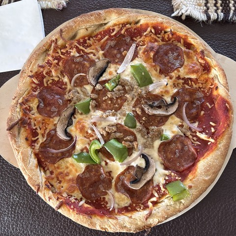 Pizza with mushroom, green pepper and pepperoni - cheese and tomato of course. 