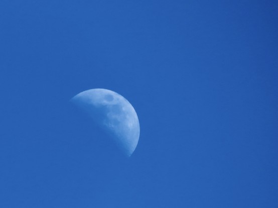The top right had side of the moon in daylight against a darkened blue sky to enhance contrast
