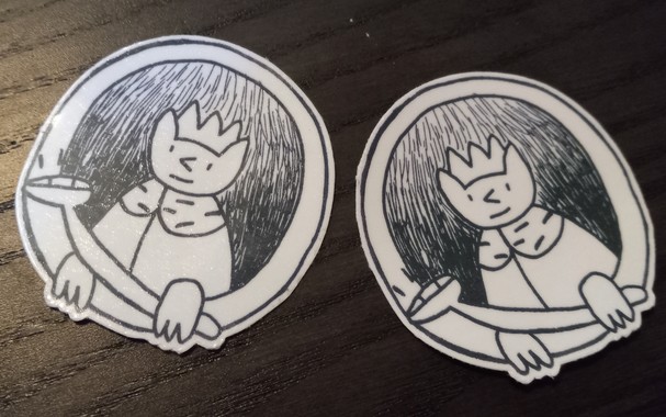 Two black-and-white King Cat logo temporary tattoos. 