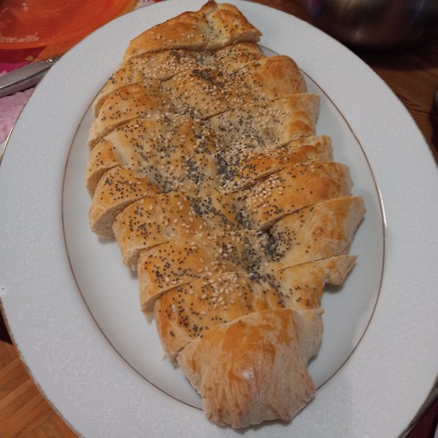 Sliced pide (Turkish flat bread) covered with sesame and poppy seeds.