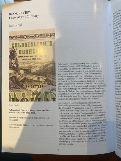 A magazine page, with an image of a book cover and a column of text.