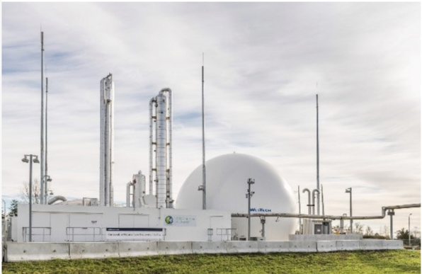 A gas production plant with several towers and a large dome all in white