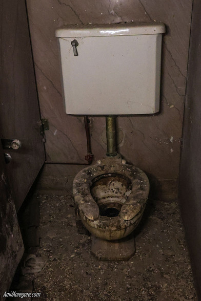  a decrepit toilet in the middle of debris