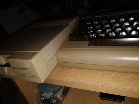 A coffee table with a breadbin C64 and 1541-II 5 1/4 inch floppy drive.