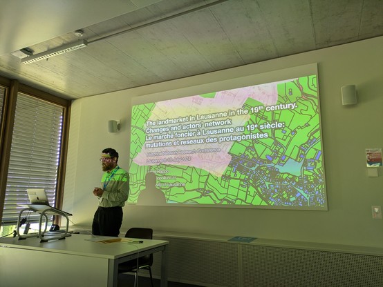 Luca's intro slide, with a GIS visualization as background.