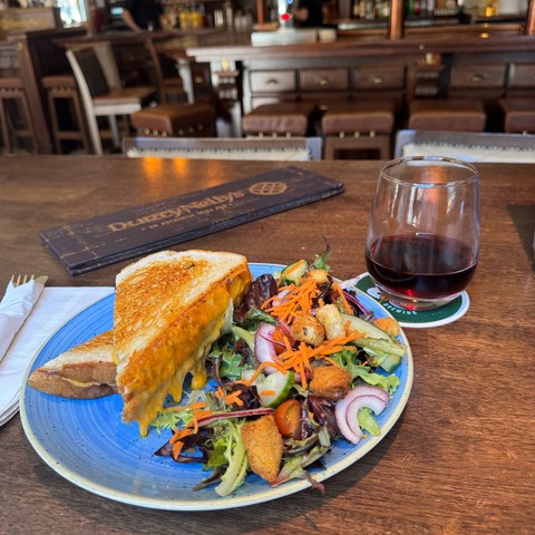 A grilled cheese sandwich and a glass of red wine at Durty Nelly's