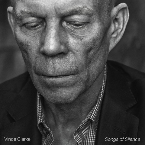 Cover of Vince Clarke - Songs of Silence
Black and white close up of Vince Clarke looking downwards. Wearing shirt and jacket with his name on the left lapel and the title of the album on the right (as we look at it).