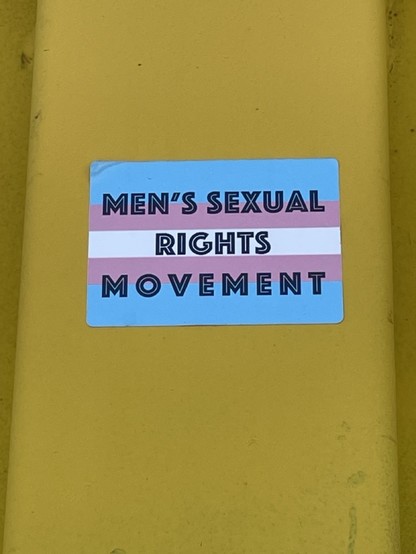 photo of a sticker on a bright yellow dumpster.  The word say 