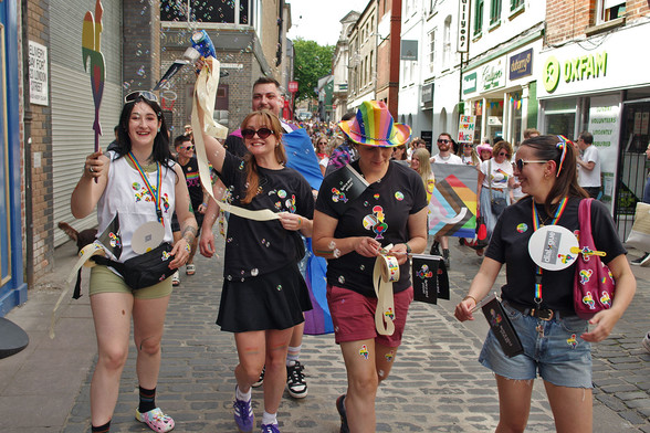 Pride marchers and dreaded sticker distribution team, smiles and bubbles