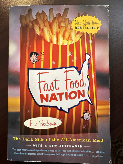 Large red, yellow-striped container of French fries with outline of the USA and little cartoon face that looks a bit like the Hi-boy fast food mascot