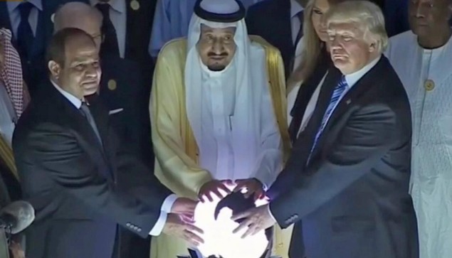 Three assholes (Donald and two of his Saudi hosts) fondling a glowing sphere for some reason.