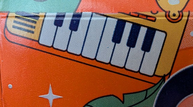 A photo of some art of a music keyboard with an incorrect amount of keys on the packaging of a case of sparkling water.