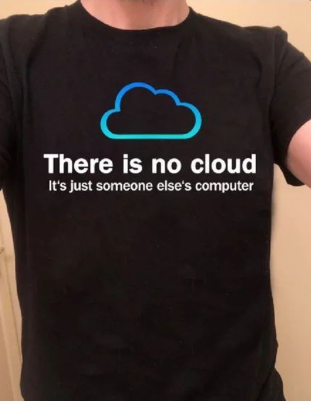 Black t-shirt with parts of an arm visible, background is a white wall On the t-shirt is the print 'there is no cloud. It's just someone else's computer'