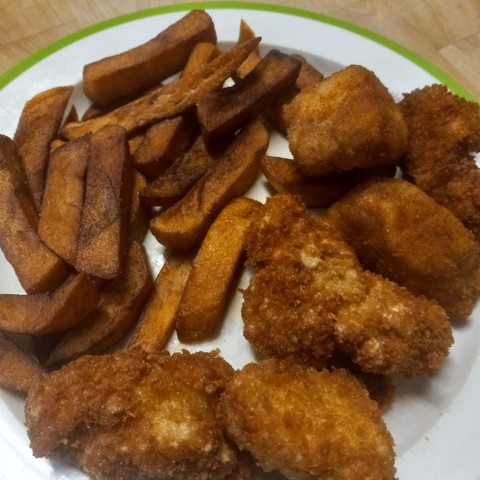 A plate of homemade fries and homemade chicken nuggets.