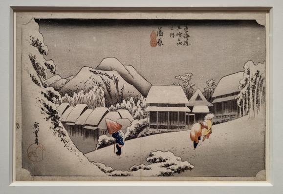 Buildings mounded with soft snow, with the figures, snow covered too, struggling through. The woodblock print is mostly monotone, with the only colour in the clothes of the people.

Utagawa Hiroshige (1797-1858)
Kanbara - Evening Snow,
about 1833-5

Colour highlights three figures
struggling through the snow. This
design is the only one of Hiroshige's
depictions of Kanbara to show the
station itself, rather than the ferry
crossing for which it was Known.
The black marks on the knees of the
man …