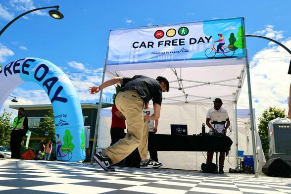 CAR FREE DAY in large friendly capital letters with somebody playing a street game 