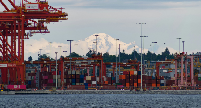 Cranes at a container berth at the Port of Vancouver (BC) with the show covered mountains in the background.  