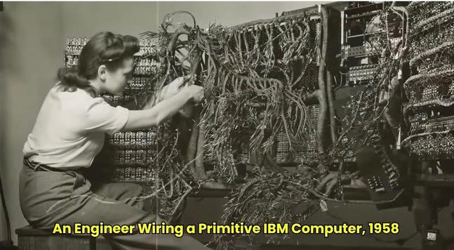 A technician wiring an early IBM computer in 1958.